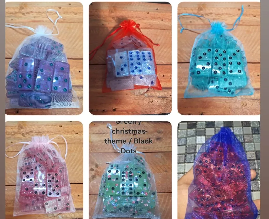 Six domino sets in coloured organza bags