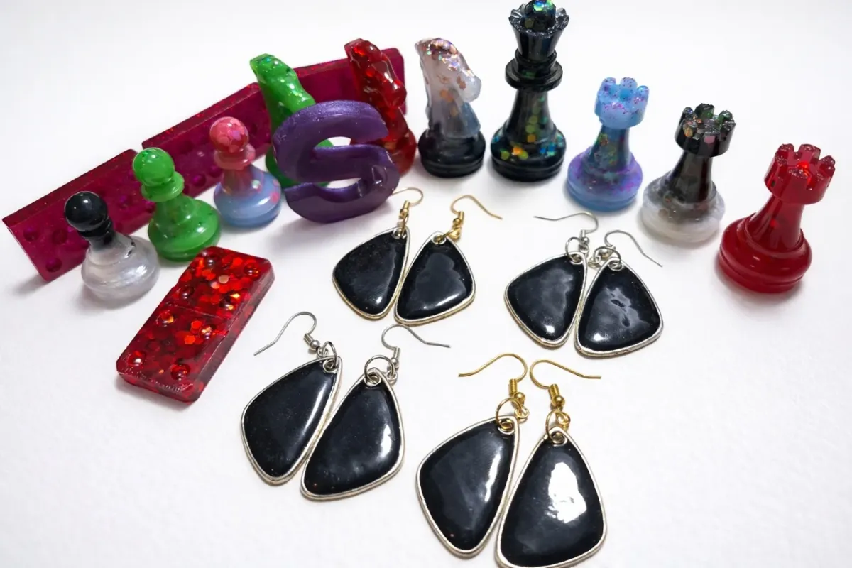 Resin earrings packed in sealed holographic pouches, with chess pieces